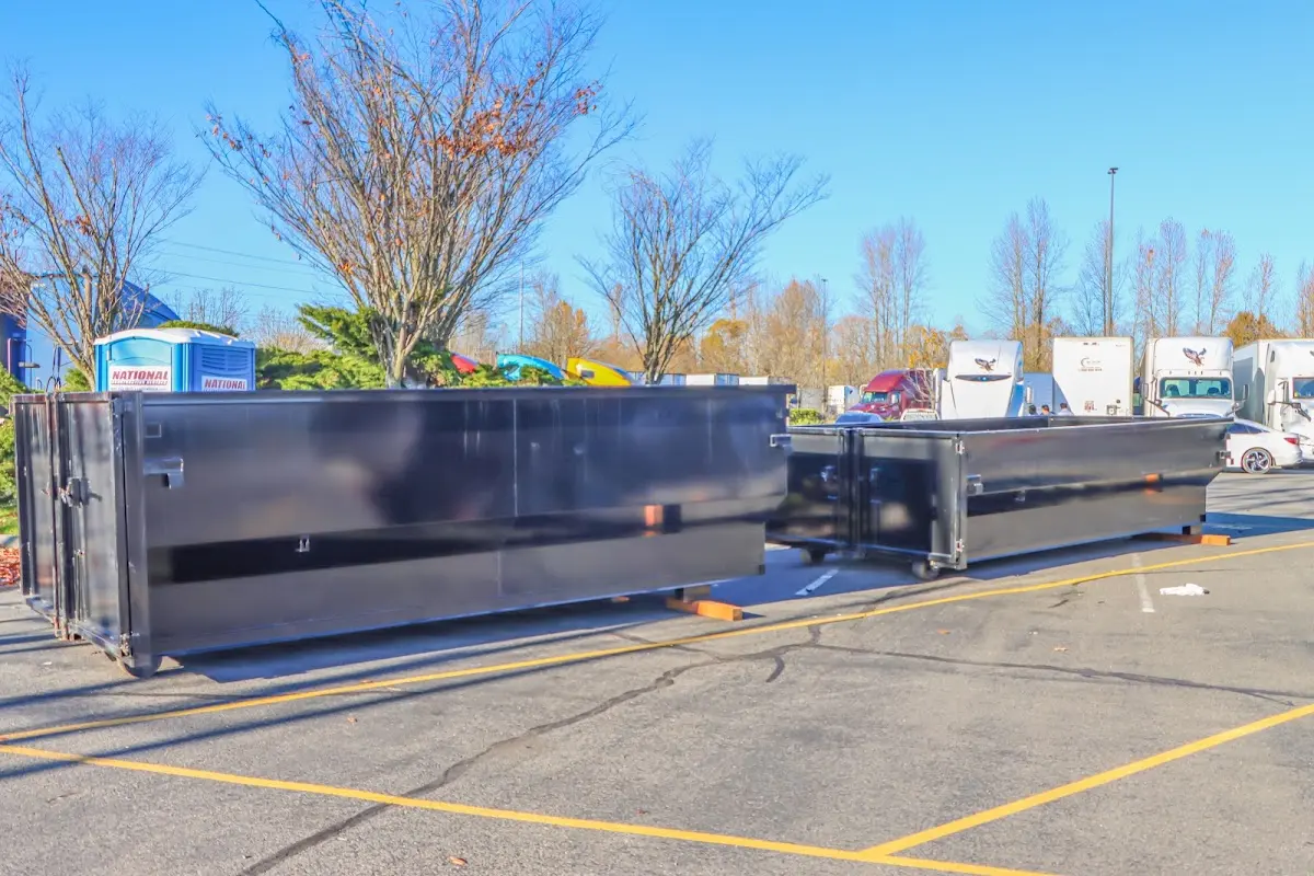 Professional dumpster rental service with roll-off container on residential driveway in New Hartford
